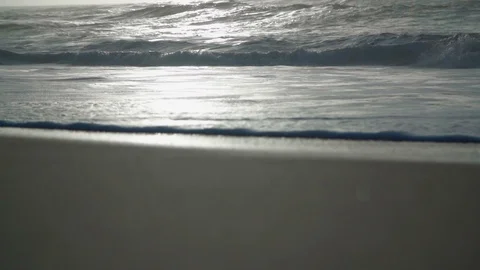 Slow motion sea with sunset in the background Stock Footage 128138839
