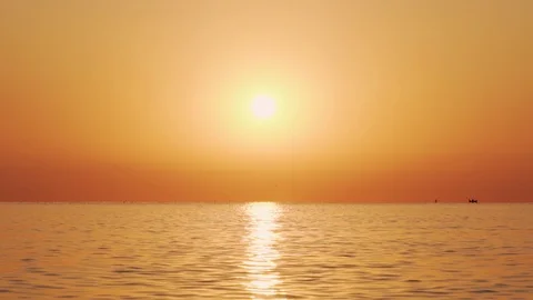 Slow motion of the sea surface with small waves against the sunrise of the sun Stock Footage 100088579