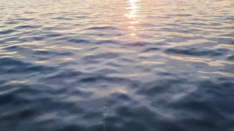 Slow motion sea surface at sunset. Calm soothing waters. Stock Footage 231697434