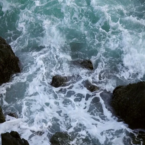 Slow motion of sea swash between boulders. Relax view of water stream Stock Footage 69333431