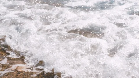 Slow motion sea view on seashore waves with foam and pebble in summer day. 4k Stock Footage 112883452