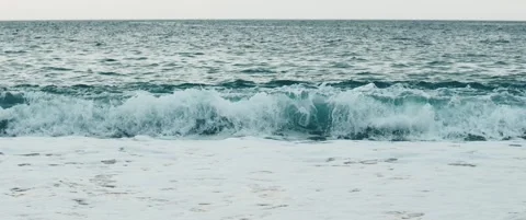 Slow motion sea wave breaking with foam Stock Footage 328936937