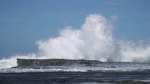Slow motion sea wave hit rock at coast with big splash Stock Footage 86773698