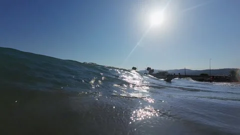 Slow motion sea wave rolling on sunny shore Stock Footage 317188116