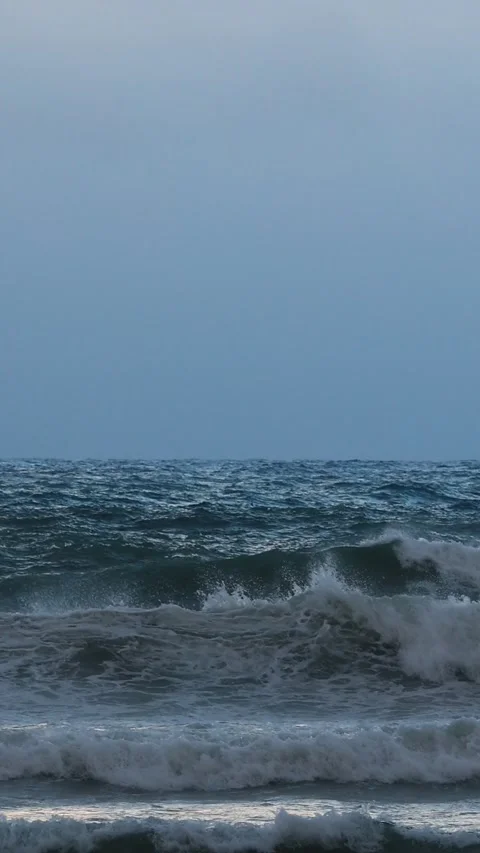 Slow Motion Sea Waves Crashing on Pebble Beach Under Cloudy Sky Stock Footage 346252694
