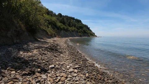 Slow motion sea waves fall on the pebble beach Stock Footage 130074375
