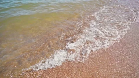 Slow motion of sea waves on a sandy shore in summer on a sunny day Stock Footage 160067398