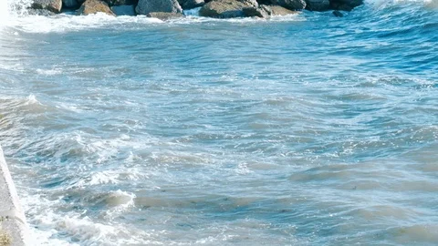 Slow motion seagulls flying over sea waves during stormy weather at daytime in Stock Footage 121533571