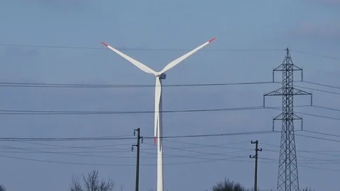 Slow motion seamless loop medium shot white wind turbine blue sky clouds clean Stock Footage 101543232
