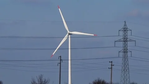 Slow motion seamless loop medium shot white wind turbine blue sky clouds clean Stock Footage 101543274