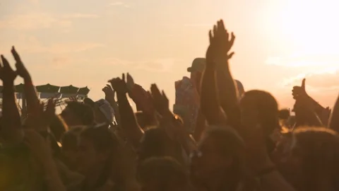 Slow motion sequence of hands of dancers at party shot against the sun. Shot on 動画素材 101021875