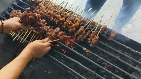 Slow motion. The serving process of Maranggi Satay on the charcoal toaster Stock Footage 247429494