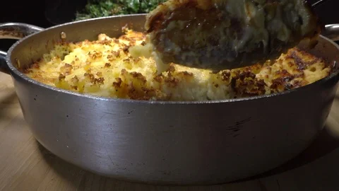 Slow motion – Serving spoon in pan of baked fish pie. Video stock 108228643