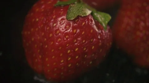 Slow motion. Shallow almost invisible drops of water on a strawberry Stock Footage 75602767