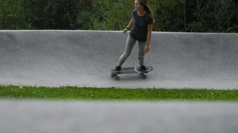 SLOW MOTION Shallow focus of a berm with young active woman riding a skateboard Stock Footage 118930146