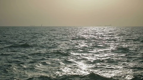 Slow motion shimmering waves reflect evening sun in sea Stock Footage 103240504