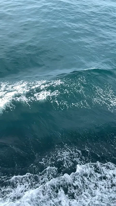 Slow Motion Ship Hull Wake with White Foam and Calm Teal Ocean Water Видео 334370015