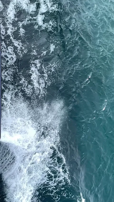 Slow Motion Ship Hull Wake with White Foam and Calm Teal Ocean Water Видео 334370723