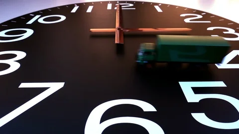 Slow motion – Shipping / delivery concept:  Model delivery truck crossing clock. Stock Footage 105152953