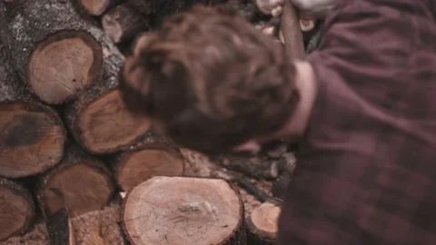 Slow motion shoot of hard chopping wood hard while smoke cigarette. Stock Footage 142108994