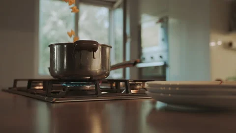 Slow motion shoot of pasta falling into boiling water Stock Footage 146309457