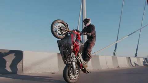 Slow motion shoot of skilled driver riding a sport bike on the back wheel and Stock Footage 105011788