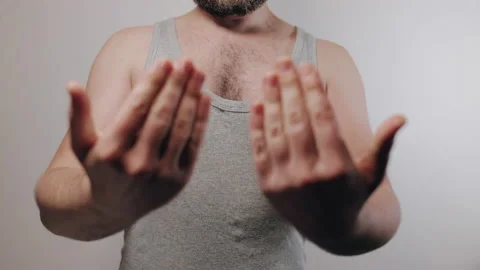 Slow motion shoot of strong man showing biceps and beckon hands gesture Stock Footage 231683643