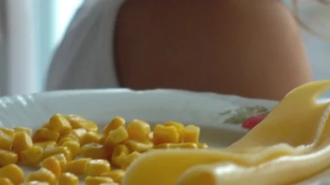 Slow motion shooting of 100 fps a child is eating corn and cheese. Stock Footage 81740139