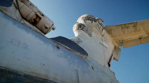 Slow-motion shooting of the engine and the rear of the plane in white against a Stock Footage 256015133