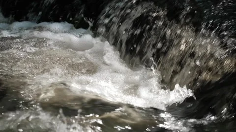 Slow motion shooting fast and powerful flow of water in mountain river. closeup. Stock Footage 254451794