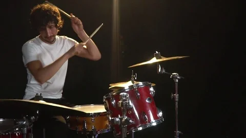 Slow-motion shooting as a man with curly hair in the leaks of light sits and Stock Footage