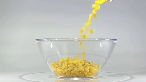 Slow-motion shooting of pasta strewing in a bowl. Stock-Footage 80678407