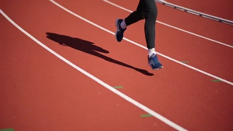 Slow motion shooting of the stadium treadmill in Nike sneakers Stock Footage 153848950
