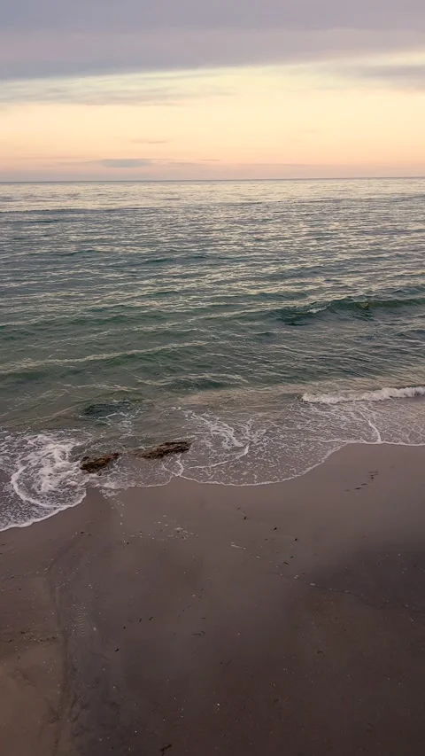 Slow motion shooting of the sunset at sea. Blue clouds over water yellow sand Stock Footage 159791933