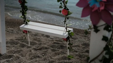 Slow-motion shooting swinging swing on shore of lake outdoors Video stock 76587313