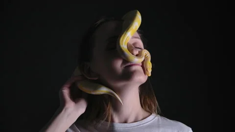 Slow motion shooting of woman with python albino crawling on her face Stock-Footage 144169253