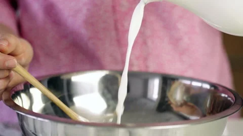 Slow motion shot of adding milk to to bowl Stock Footage 62433619