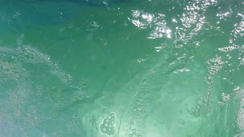 Slow motion shot of air bubbles coming out to the surface of a jacuzzi pool Video stock 203858614