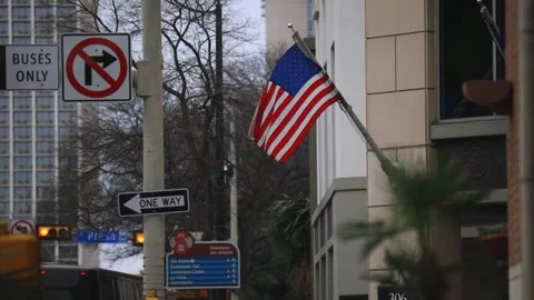 A slow motion shot of an American flag in the city. Stock Footage 301198653