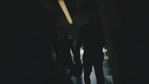 Slow motion shot of American football players walking through tunnel to field Stock Footage
