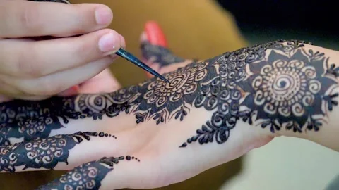 Slow motion shot of applying design of hina mehndi on hand  big close up (4) Stock Footage 199278861