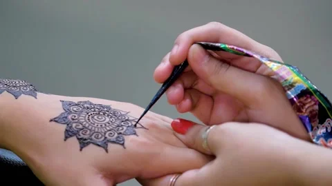 Slow motion shot of applying design of hina mehndi on hand  big close up Stock Footage 199278865