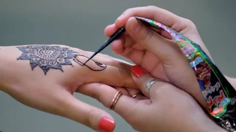 Slow motion shot of applying design of hina mehndi on hand  big close up (2) Stock Footage 199278906