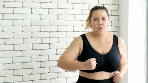Slow motion shot of Asian plus size girl is running in fitness room Stock Footage 116746409