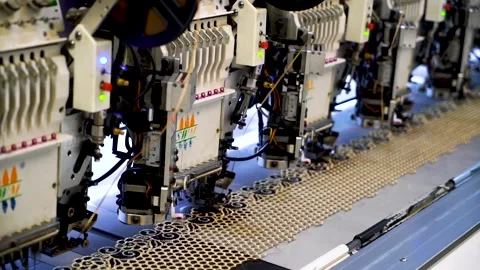 Slow motion shot of automatic embroidery machine with multiple heads in text Stock Footage 199272333