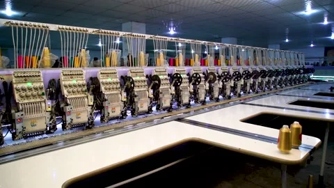 Slow motion shot of automatic embroidery machine with multiple heads in text Stock Footage 199272406