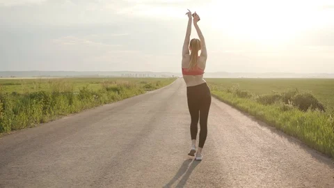 Slow motion shot back young woman in headphones dancing to camera having fun in Stock Footage 112746016