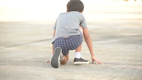 Slow motion shot from a back of young boy from prepare to starting run Stock Footage 122101726