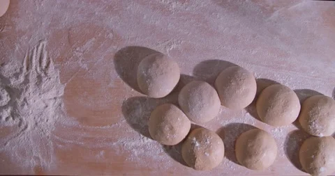 Slow Motion shot of bakery chef applying and sprinkles flour over bread dough Stock Footage 156334826