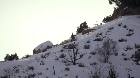 Slow-motion shot of basejumper with skiis and parachute. Stock Footage 52225642